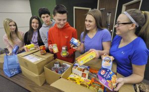 McDowell High School freshman students in the Leadership Class of the McDowell Honors College display food collected while participating in the Lead2Feed program that engages young people in solving hunger issues. The students are, from left, Madison Niemenski, 15, Tori Berlin, 14, Eric Adams, 14, Jared Fisher, 14, Madeline Cacchione, 15 and Olivia Minichelli, 15. GREG WOHLFORD/ERIE TIMES-NEWS